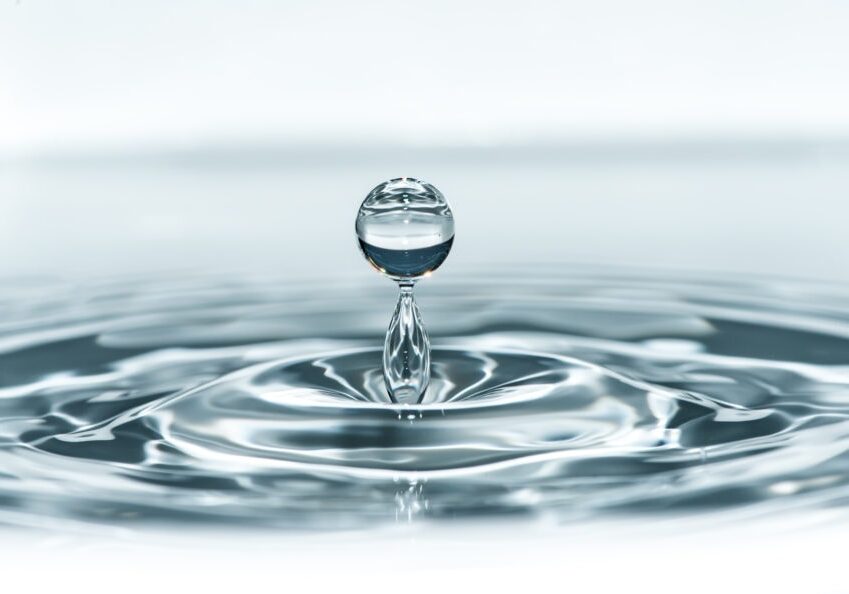 Drop in water. Blue waterdrop macro shot